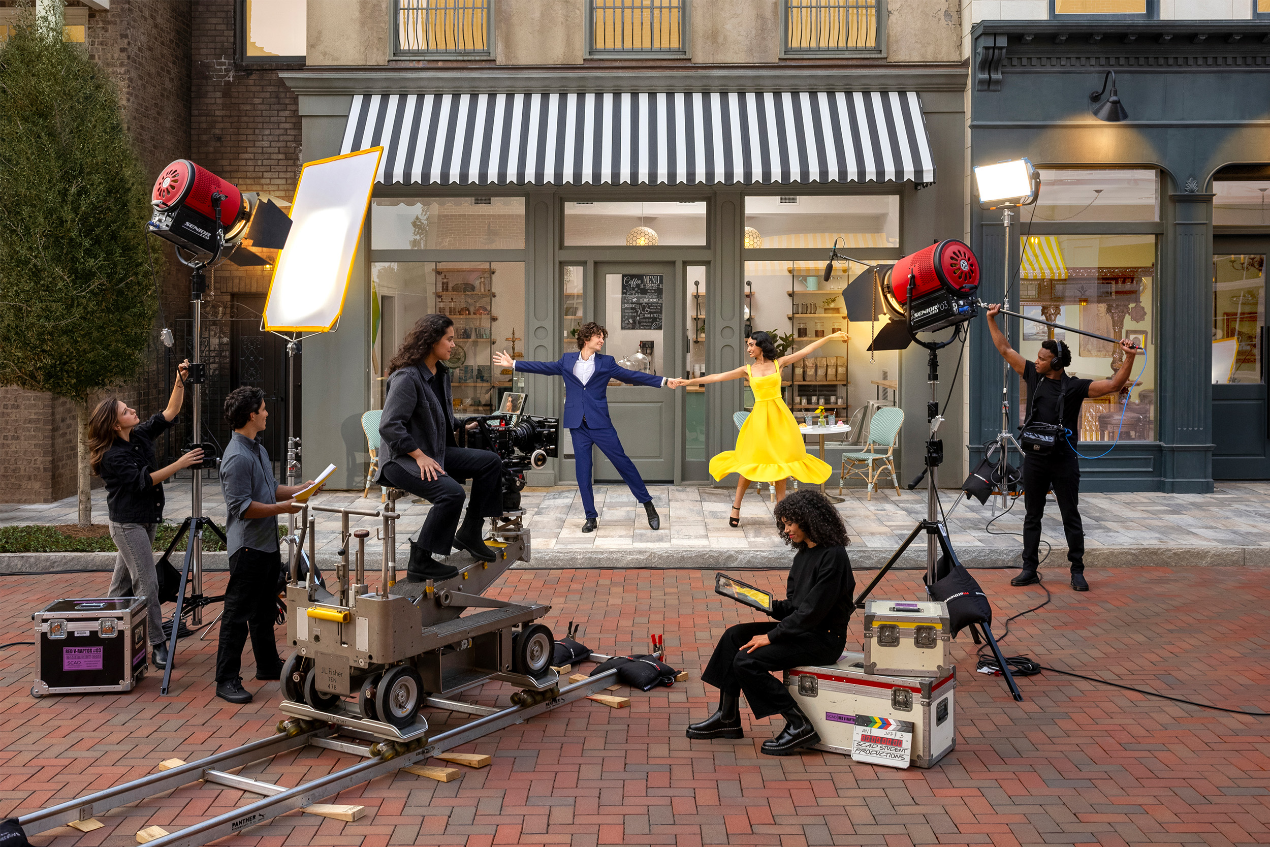 Shooting a scene of a couple dancing in front of backlot cafe